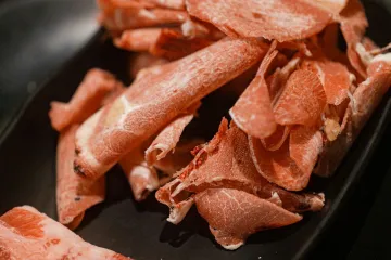 Thịt thái lát trên đĩa đen